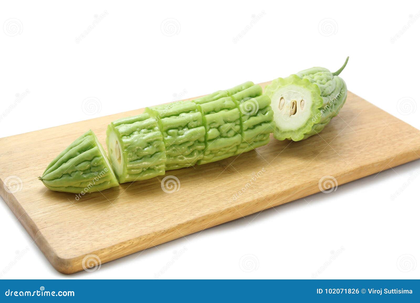 bitter melon or bitter gourd sliced Ã¢â¬â¹Ã¢â¬â¹on wooden cutting boards on white background.